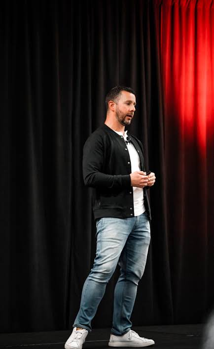 Alex Pardo speaking on stage